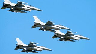 US-made F-16 fighter jets fly in the sky over Warsaw as they take part in a massive military parade.