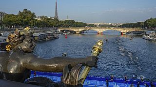 Athletes swim in the Seine river from the Alexander III bridge on the first leg of the women's triathlon test event for the Paris 2024 Olympics Games. Paris, Aug. 17, 2023 