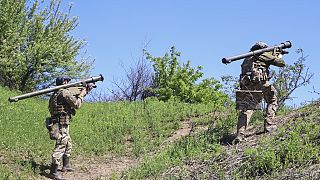 Ukrainian soldiers carry "Igla" rocket launchers to their position near Bakhmut in the Donetsk region, Ukraine, Thursday, May 4, 2023. 