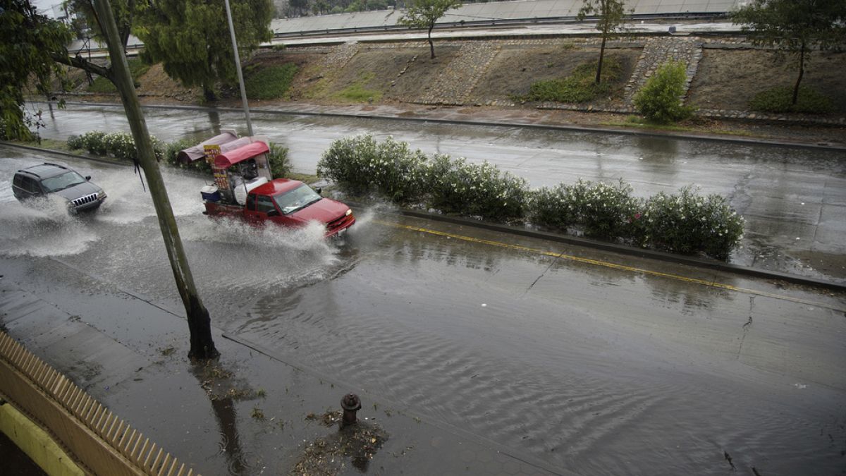 Vehicles make their way through a flooded road in Zona Rio as Tropical Storm Hilary hits the region on Sunday, Aug. 20, 2023, in Tijuana, Baja California.