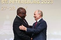 President of the Republic of South Africa Cyril Ramaphosa, left, and Russian President Vladimir Putin shake hands in St Petersburg, Russia, July 27, 2023.