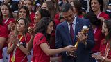 Spain's acting Prime Minister Pedro Sanchez holds the trophy next to Spain's Ivana Andres after their World Cup victory, at La Moncloa Palace in Madrid, August 22, 2023. 