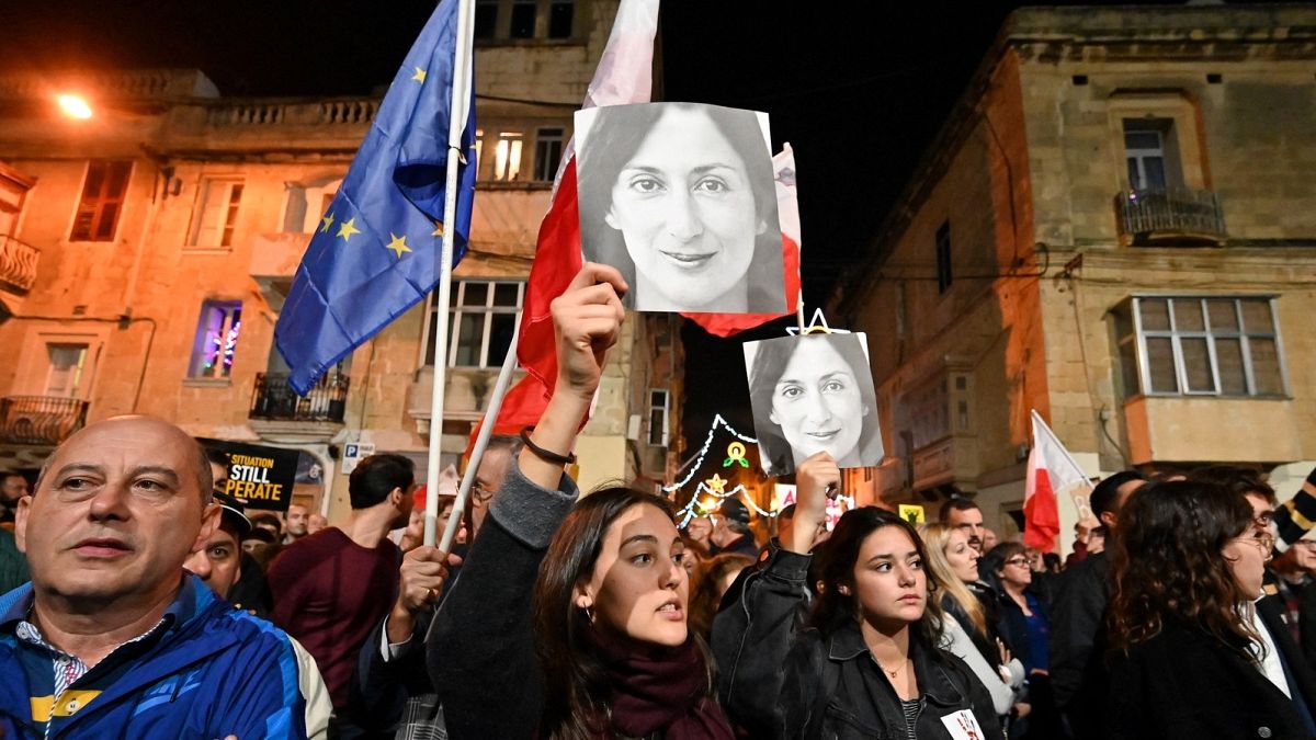 People hold placards and photos of killed journalist Daphne Caruana Galizia during a protest called for by Galizia's family and civic movements