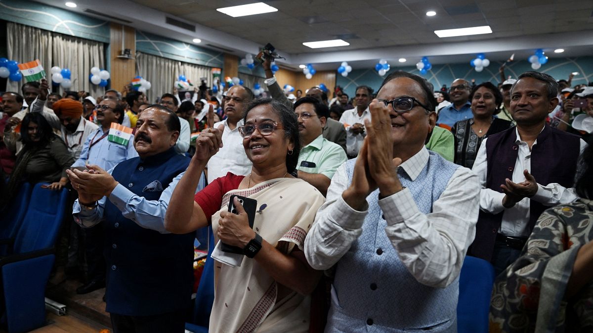 Minister of State for Science and Technology Jitendra Singh (L, front) along with others celebrate the successful lunar landing of Chandrayaan-3 spacecraft.