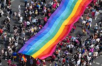 People hold a rainbow flag as they attend the 45th Berlin Pride Parade for Christopher Street Day (CSD) in Berlin, Germany, Saturday, July 22, 2023. 