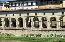 The spray-painted graffiti on exterior columns of the Vasari Corridor