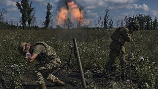 Ukrainian soldiers fire a mortar towards Russian positions at the front line, near Bakhmut, Donetsk region