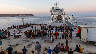 Migrant centreMigrants wait to board an Italian Coast Guard ship in the Sicilian Island of Lampedusa, Italy.  in Lampedusa