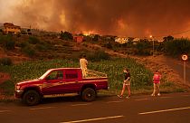 Residents try to reach their houses in Benijos village as a wildfire advances in La Orotava in Tenerife, Canary Islands, Spain in August 2023