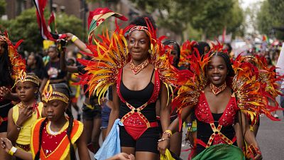 Participant dressed in costume attend the first day of the Notting Hill Carnival