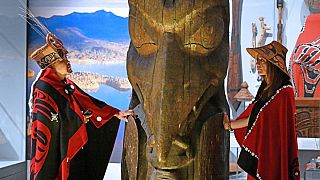 Amy Parent, right, is shown with the Ni'isjoohl memorial pole alongside Nisga'a Chief Earl Stephens during a visit to the National Museum of Scotland