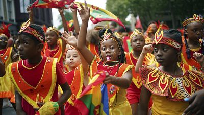 Participants dance during the Children's Day Parade, part of the Notting Hill Carnival celebration in west London