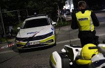 Police stand guard in the Freetown Christiania neighbourhood of Copenhagen, Denmark, Saturday, Aug. 26, 2023.