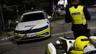 Police stand guard in the Freetown Christiania neighbourhood of Copenhagen, Denmark, Saturday, Aug. 26, 2023. 
