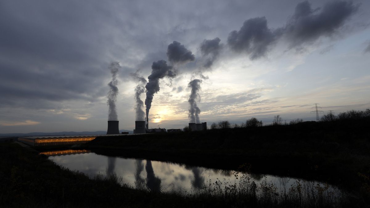 smoke rises from chimneys of the Turow power plant located by the Turow lignite coal mine near the town of Bogatynia, Poland.