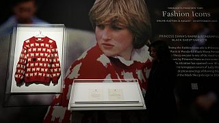 A Sotheby's employee looks at the historic Princess Diana black sheep jumper at the auction house Sotheby's in London, Monday, July 17, 2023.