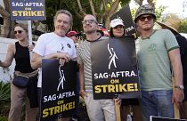 Rhea Seehorn, from left, Bryan Cranston, Aaron Paul, Betsy Brandt and Jesse Plemons, from the cast of "Breaking Bad," strike on a picket line outside Sony Pictures studios