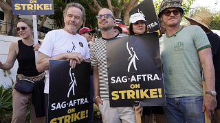 Rhea Seehorn, from left, Bryan Cranston, Aaron Paul, Betsy Brandt and Jesse Plemons, from the cast of "Breaking Bad," strike on a picket line outside Sony Pictures studios
