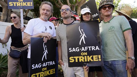 Rhea Seehorn, from left, Bryan Cranston, Aaron Paul, Betsy Brandt and Jesse Plemons, from the cast of "Breaking Bad," strike on a picket line outside Sony Pictures studios