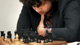 Шахматный гроссмейстер Ханс Ниманн (19) изучает доску во время матча с гроссмейстером Кристофером Ю (15) на чемпионате США по шахматам в Сент-Луисе, 5 октября 2022 г.