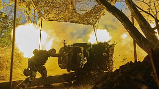 FILE - A Ukrainian serviceman of the 10th Assault Brigade Edelweiss fires a D-30 cannon towards Russian positions at the front line, near Bakhmut, Ukraine, July, 2023.