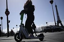 A woman rides a scooter in Paris, Friday, march 31, 2023. 
