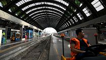 An employee looks on at the Milan Central train station as Italy's rail workers are on strike in Milan, on July 13, 2023.