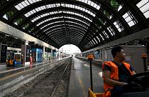 An employee looks on at the Milan Central train station as Italy's rail workers are on strike in Milan, on July 13, 2023. 