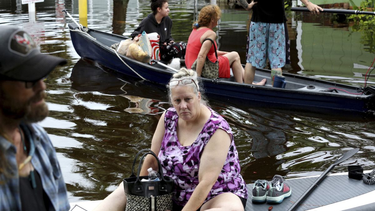Residents of Twin City Mobile Home Park, navigate through the neighborhood in high waters, Wednesday, Aug. 30, 2023, in St. Petersburg, Florida