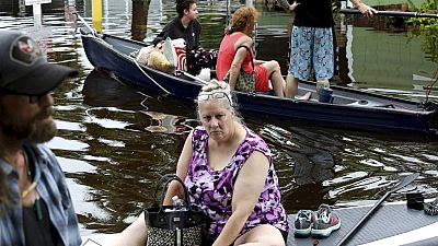 Residents of Twin City Mobile Home Park, navigate through the neighborhood in high waters, Wednesday, Aug. 30, 2023, in St. Petersburg, Florida