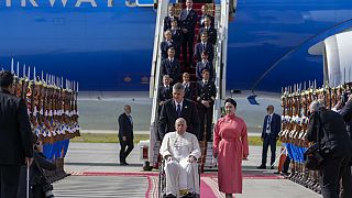 Pope Francis is received by the Foreign Minister of Mongolia, Batmunkh Battsetseg, right, as he arrives at Ulaanbaatar's International airport Chinggis Khaan, Friday, Sept. 1,