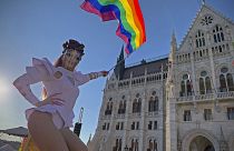 A drag performer waves a rainbow flag during an LGBT rights demonstration in front of the Hungarian parliament in Budapest. 14 June 2021