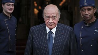 Egyptian businessman and Ritz hotel owner Mohamed Al Fayed poses with his hotel staff in Paris in June 2016