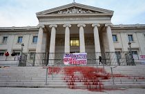 A protest at the Marseille courthouse features red dye representing the blood of victims of feminicide in March