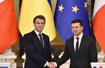 Ukrainian President Volodymyr Zelenskyy and his French counterpart Emmanuel Macron shake hands in Kyiv, 2022