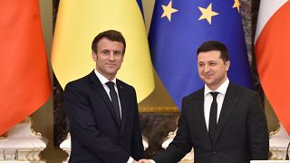 Ukrainian President Volodymyr Zelenskyy and his French counterpart Emmanuel Macron shake hands in Kyiv, 2022