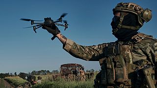A Ukrainian soldier of the 28th brigade launches a drone at the frontline close to Bakhmut, Ukraine, Sunday, Aug. 20, 2023. 