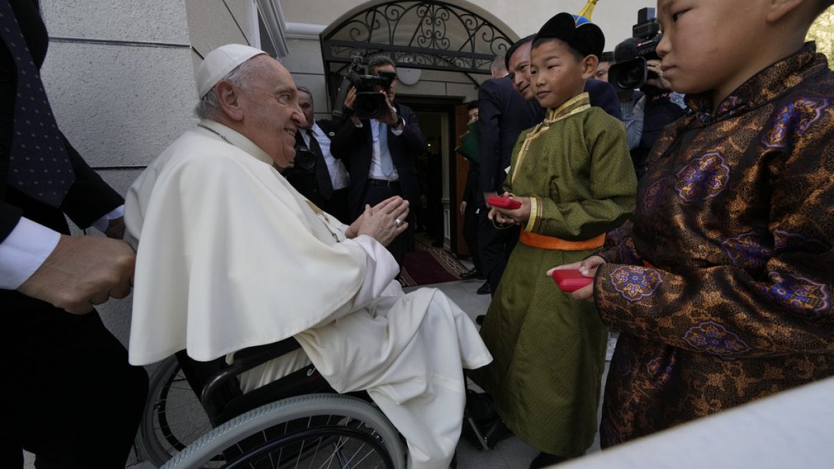 Children in traditional dress welcome Pope Francis arriving for a meeting with charity workers and for the inauguration of the House of Mercy in Ulaanbaatar, Monday, Sept. 4.