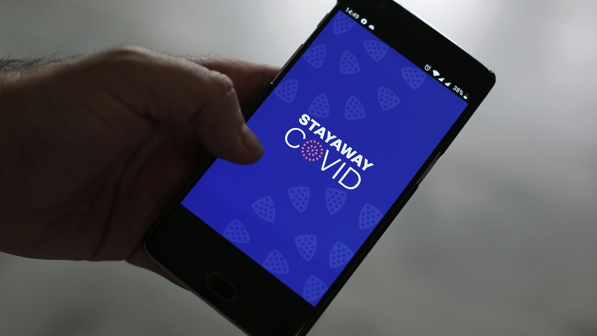A man shows the contact tracing app Stayaway Covid on his cellphone, in Lisbon.