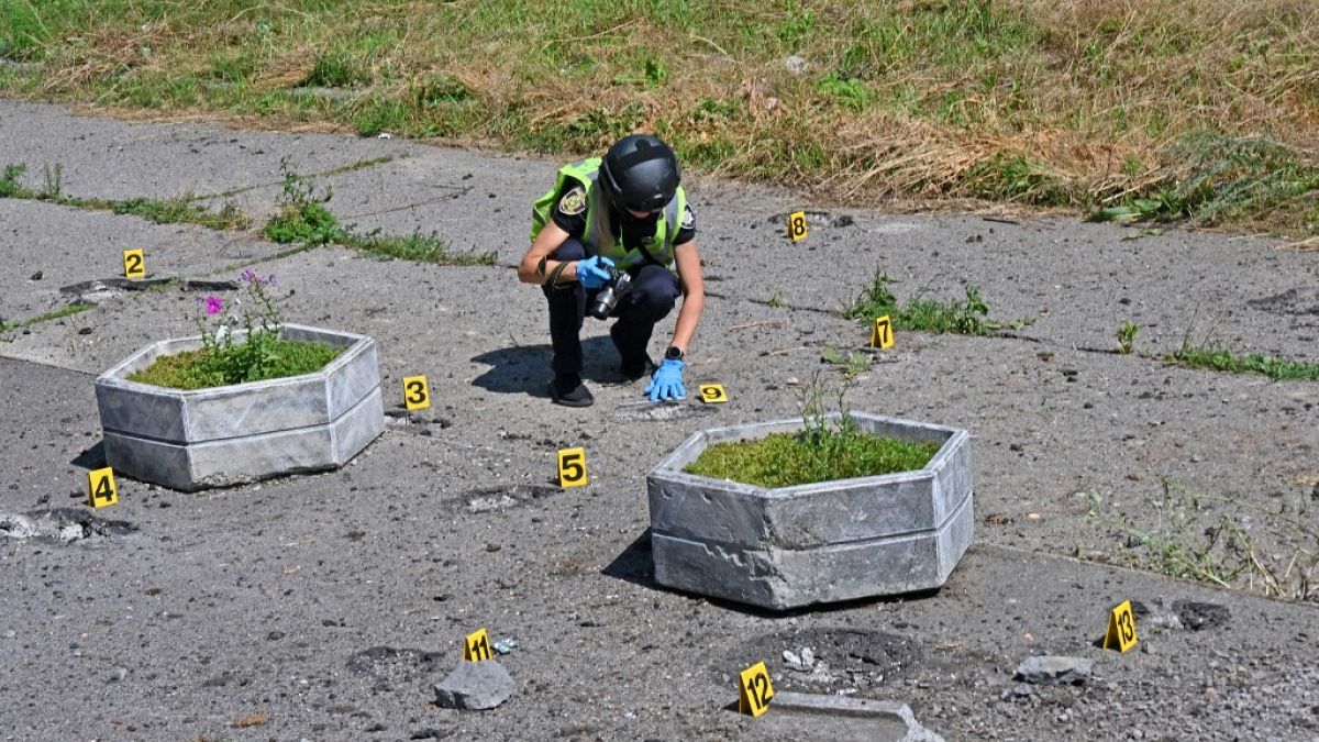 A deminer checks the site of a cluster munition fall after a Russian rocket attack killed a resident in northern Kharkiv, August 8, 2022