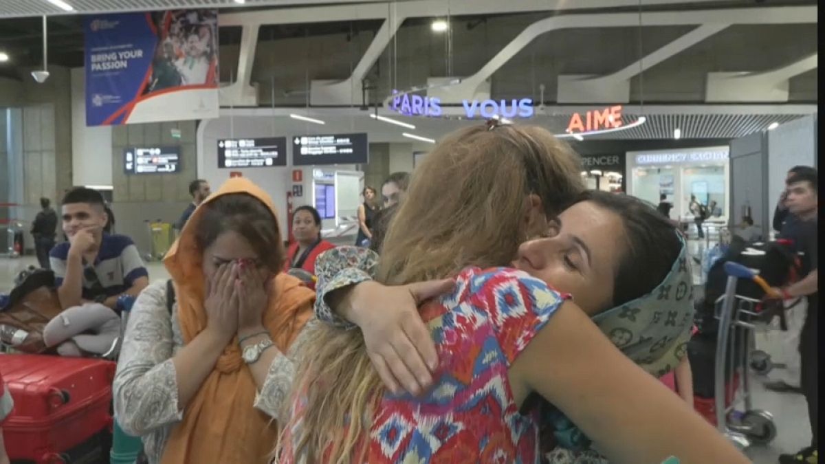 Afghan women threatened by the Taliban and exiled in neighbouring Pakistan arrive at Roissy airport in Paris.