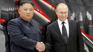 Russian President Vladimir Putin and North Korea's leader Kim Jong Un shake hands during a meeting.