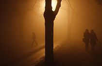 Bosnian people walking on the street during heavy smog in northern Bosnian town of Tuzla, 140 kms. north of Sarajevo, Monday, Dec. 16, 2013.