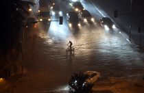 A cyclist rides through floodwater blocking the road due to heavy rain in Basaksehir district of Istanbul, Turkey, Tuesday, Sept. 5, 2023.
