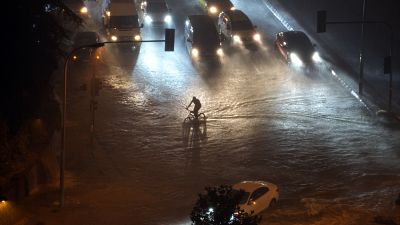 A cyclist rides through floodwater blocking the road due to heavy rain in Basaksehir district of Istanbul, Turkey, Tuesday, Sept. 5, 2023. A cyclist rides through floodwater blocking the road due to heavy rain in Basaksehir district of Istanbul, Turkey, Tuesday, Sept. 5, 2023.