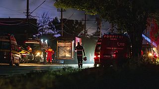 A Romanian firefighter leaves the site of a blaze after several explosions at a fueling station that provides LPG (liquefied petroleum gas), in Crevedia, Romania.