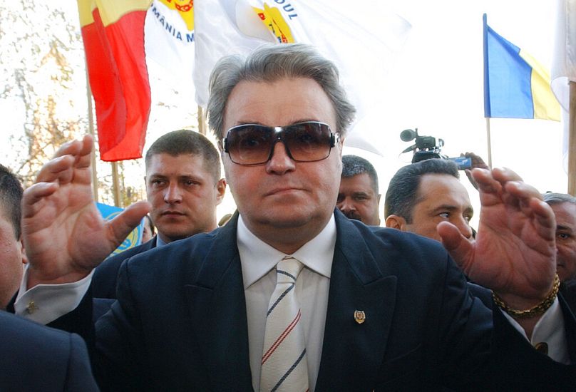 Nationalist leader Corneliu Vadim Tudor, representing the Greater Romania party in the presidential race, waves to supporters during a rally in Ploiesti, Novembe 2004