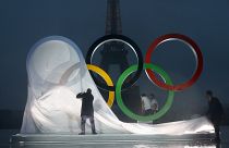 Paris officials unveil a display of the Olympic rings on Trocadero plaza that overlooks the Eiffel Tower in Paris, Wednesday, Sept. 13, 2017.