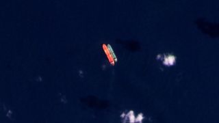 In this satellite photo provided by Planet Labs PBC, vessels identified as the Virgo, left, and the Suez Rajan, by the advocacy group United Against Nuclear Iran, are seen in