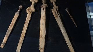 The 1,900-year-old weapons were discovered inside a cave overlooking the body of water. 